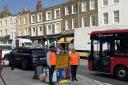 Volunteers Helen Rapley and Taha Gulamhusein directing traffic in Highgate High Street