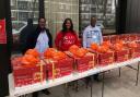 Christ Royal Church members with the Christmas Hampers, which are being given out on a first come, first serve basis.