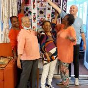 Nolly Mignol Gregory with her fellow Sparko friends and her community quilt.