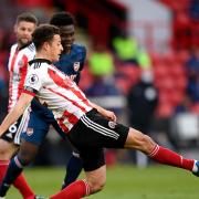 Sheffield United's Ethan Ampadu clears the ball under pressure from Arsenal's Bukayo Saka during the Premier League match at at Bramall Lane, Sheffield. Picture date: Sunday April 11, 2021.