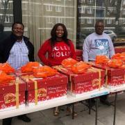 Christ Royal Church members with the Christmas Hampers, which are being given out on a first come, first serve basis.