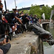 Protesters throw statue of Edward Colston into Bristol harbour during a Black Lives Matter protest rally. Photo: Ben Birchall/PA Wire.