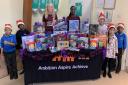 Viviane Asseyi and Grace Fisk with Santa's helpers at the Terence Brown Arc in the Park hub