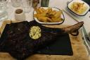 The 32oz tomahawk steak, peppercorn sauce, thick cut chips, and garlic and truffle oil mash.