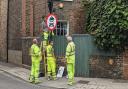 Workers installing signs for the Stoke Newington Church Street LTN, which will now allow Blue Badge holders exemption.