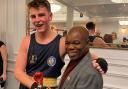 Lion Boxing Academy member Rocky Faye receives an award from boxer Francis Ampofo