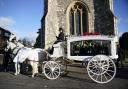 A horse-drawn carriage carrying the coffin of Liam Payne arrives for the funeral service of One Direction singer