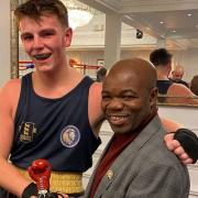 Lion Boxing Academy member Rocky Faye receives an award from boxer Francis Ampofo