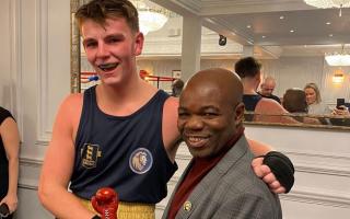 Lion Boxing Academy member Rocky Faye receives an award from boxer Francis Ampofo